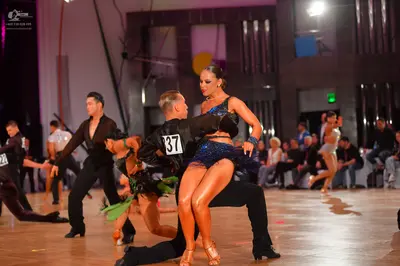 Dancesport competitor #37: Male dancer (center): black long-sleeved shirt and black trousers