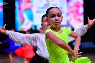 Dancesport competitor: Female dancer: lime green latin dance dress