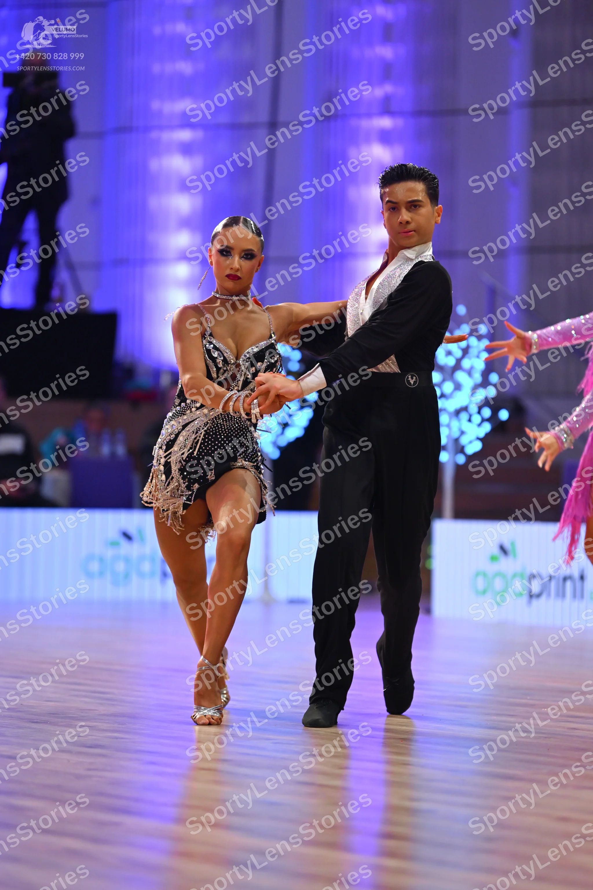 Dancesport competitor: Female dancer: dark grey/black sequined latin dress with thin straps and fringe/