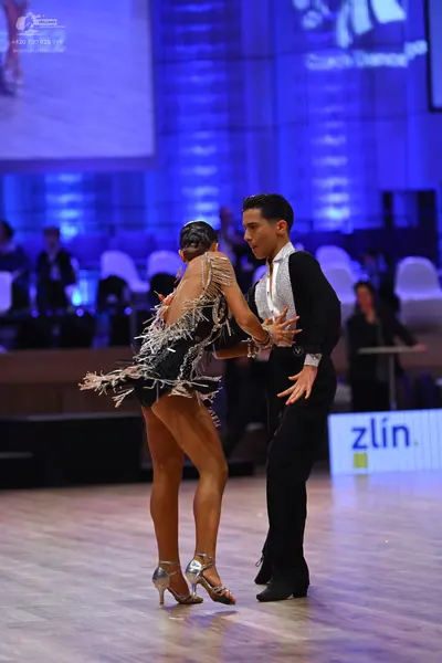 Dancesport competitor: Male dancer: black long-sleeved shirt with a white front panel and black trouser