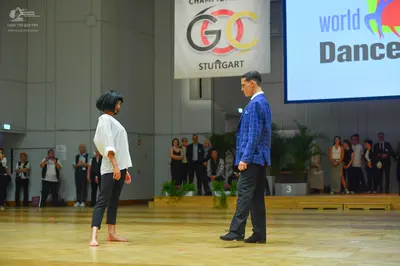 Dancesport competitor: Female dancer: white long-sleeved blouse and black cropped trousers