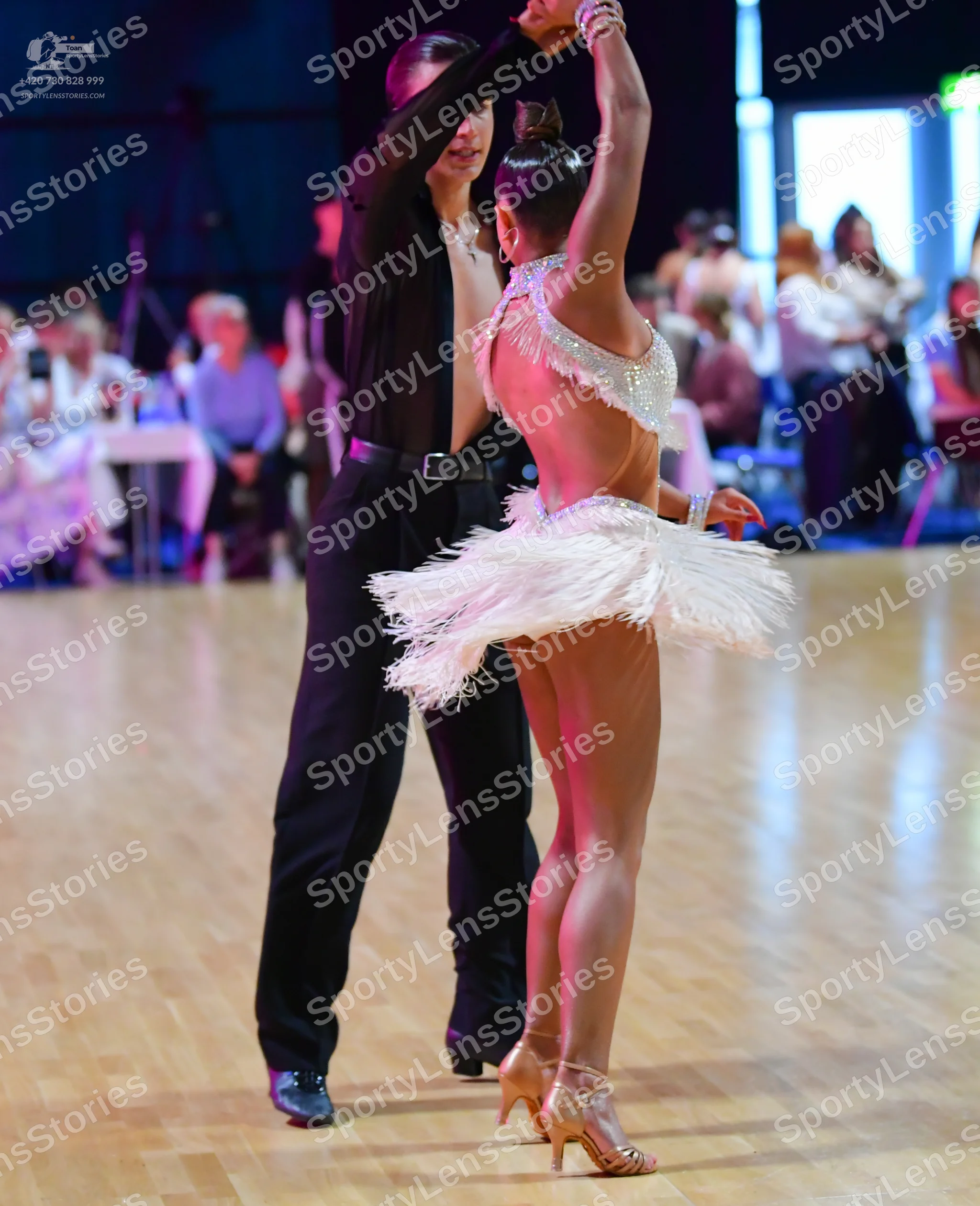 Dancesport competitor: Male dancer: black long-sleeved shirt, black trousers, black belt with silver bu