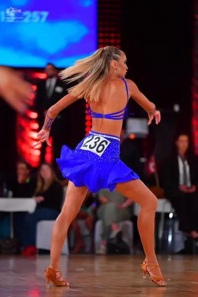 Dancesport competitor #236: Female dancer: blue two-piece latin costume covered in sequins