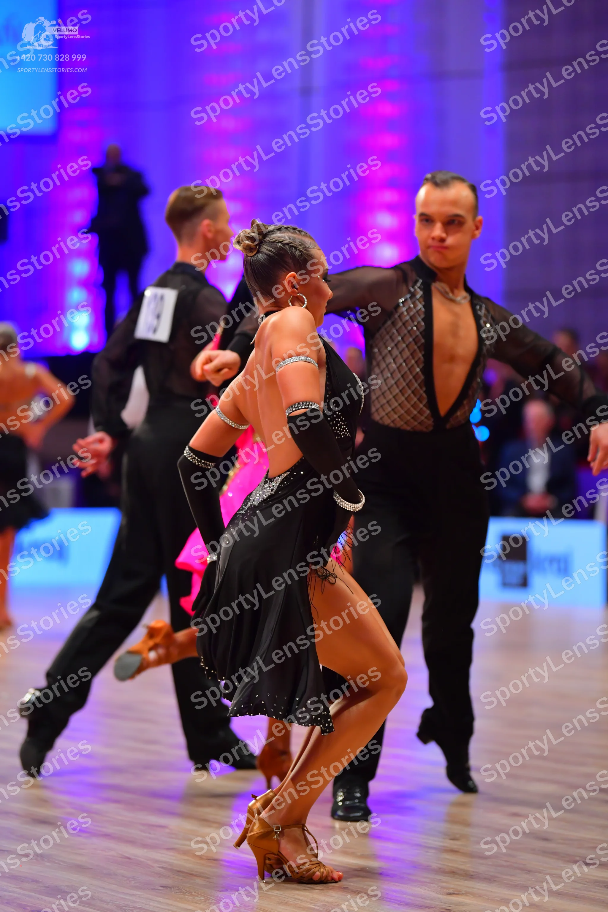 Dancesport competitor: Male dancer (left): black long-sleeved shirt and black trousers