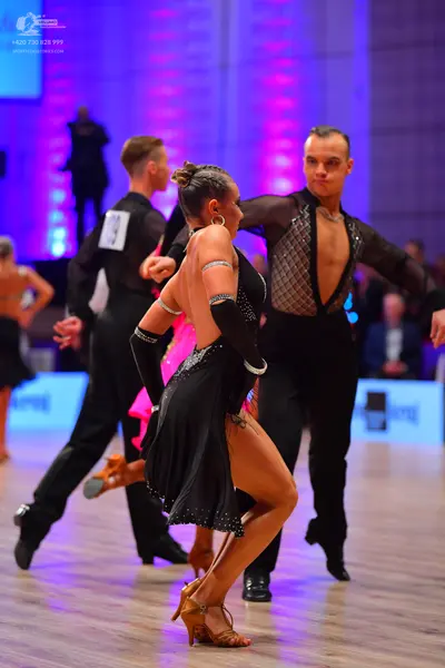 Dancesport competitor: Male dancer (left): black long-sleeved shirt and black trousers