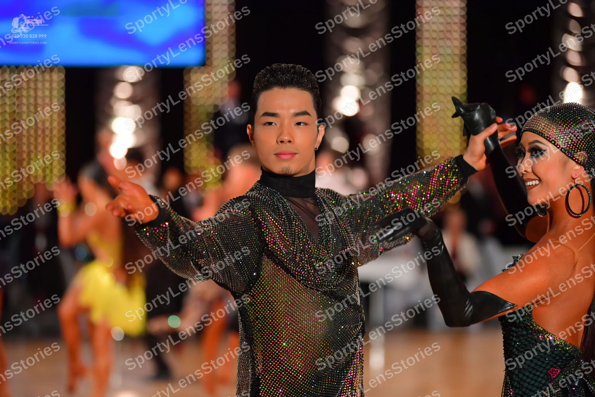 Dancesport competitor: Male dancer: dark long-sleeved top with multicolored sequins