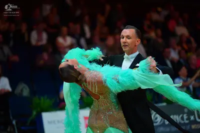 Dancesport competitor: Male dancer: black suit with white shirt and white bow tie