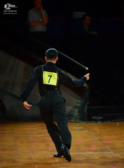 Dancesport competitor: Male dancer: black long-sleeved shirt and black trousers