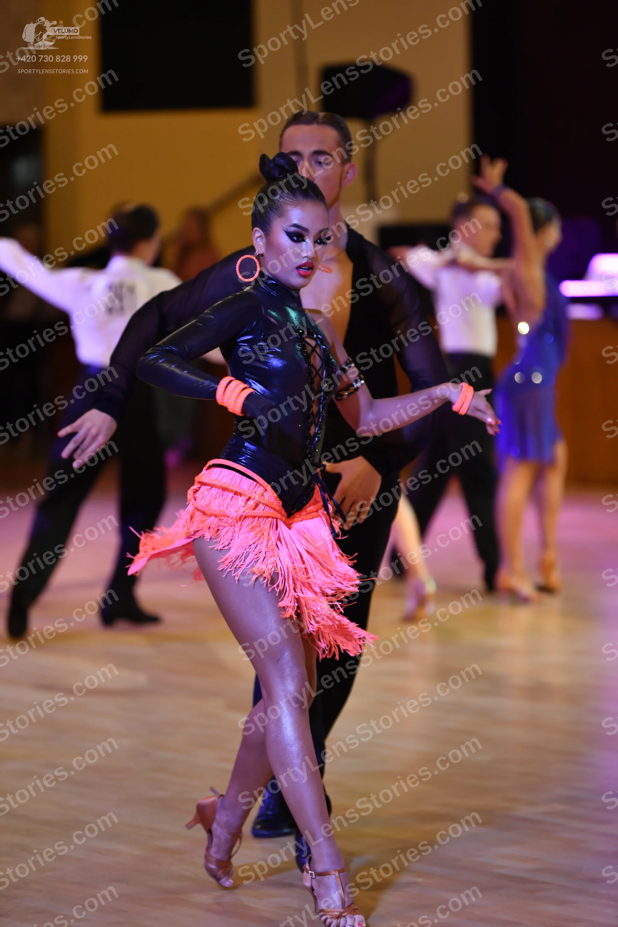 Dancesport competitor: ** Red Latin Dress
*   **Color:** Bright Red
*   **Fabric:** Appears to be a sat