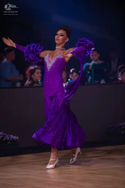 Dancesport competitor: Female dancer: purple satin-like latin dress with a sequined/rhinestone bodice, 