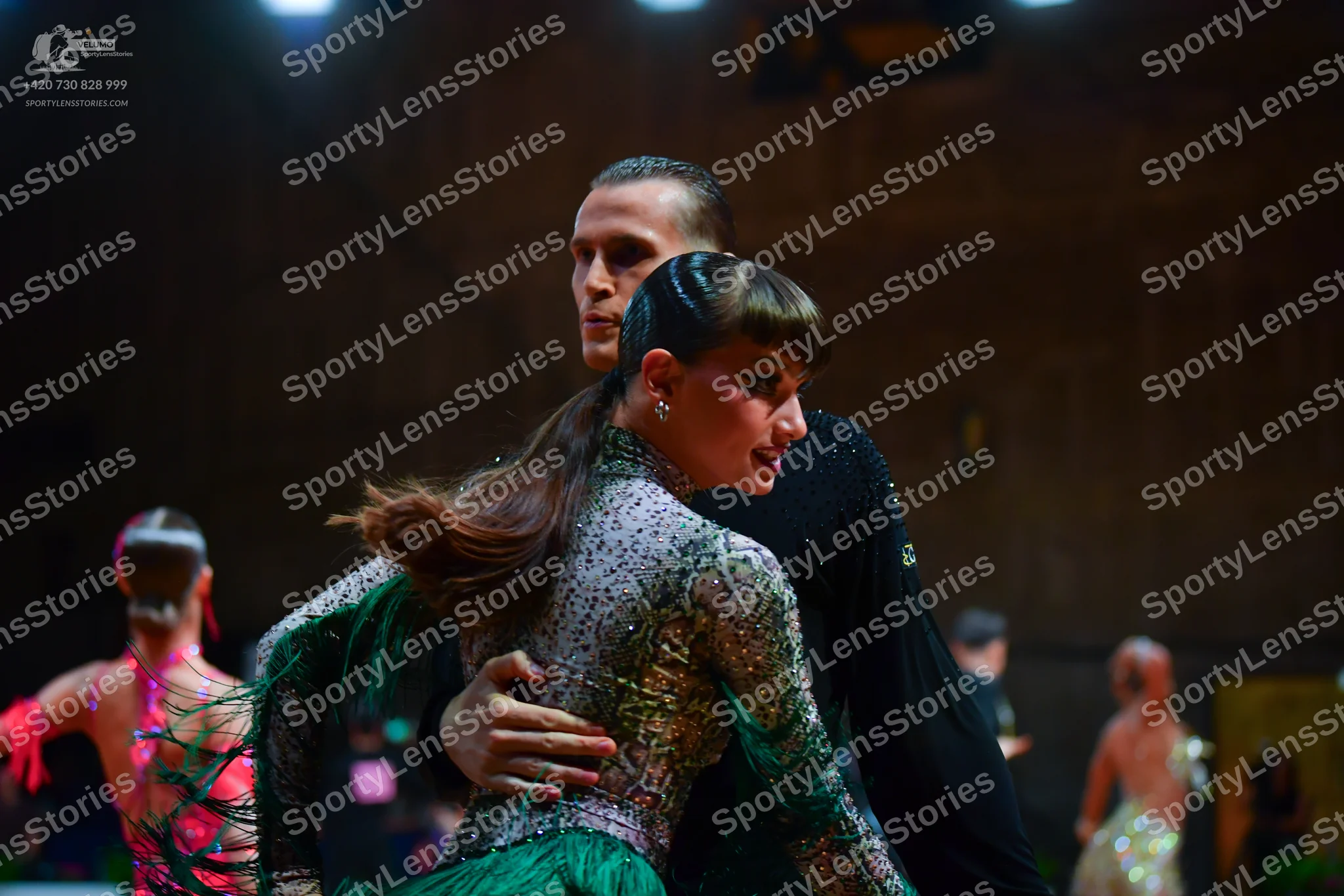 Dancesport competitor: Main female dancer: silver/grey sequined long-sleeved bodice with a bright green