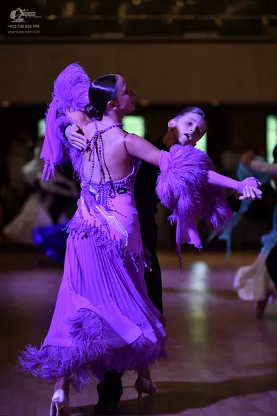 Dancesport competitor: ** Black suit with a white ruffled neckline and matching tails