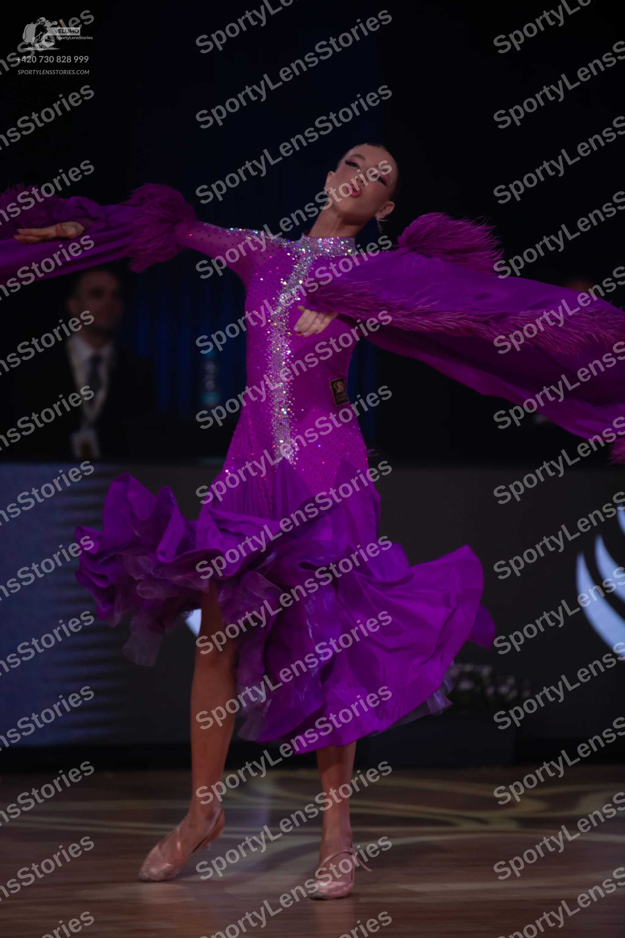 Dancesport competitor: Female dancer: purple latin dress with large ruffles on the sleeves and skirt, f