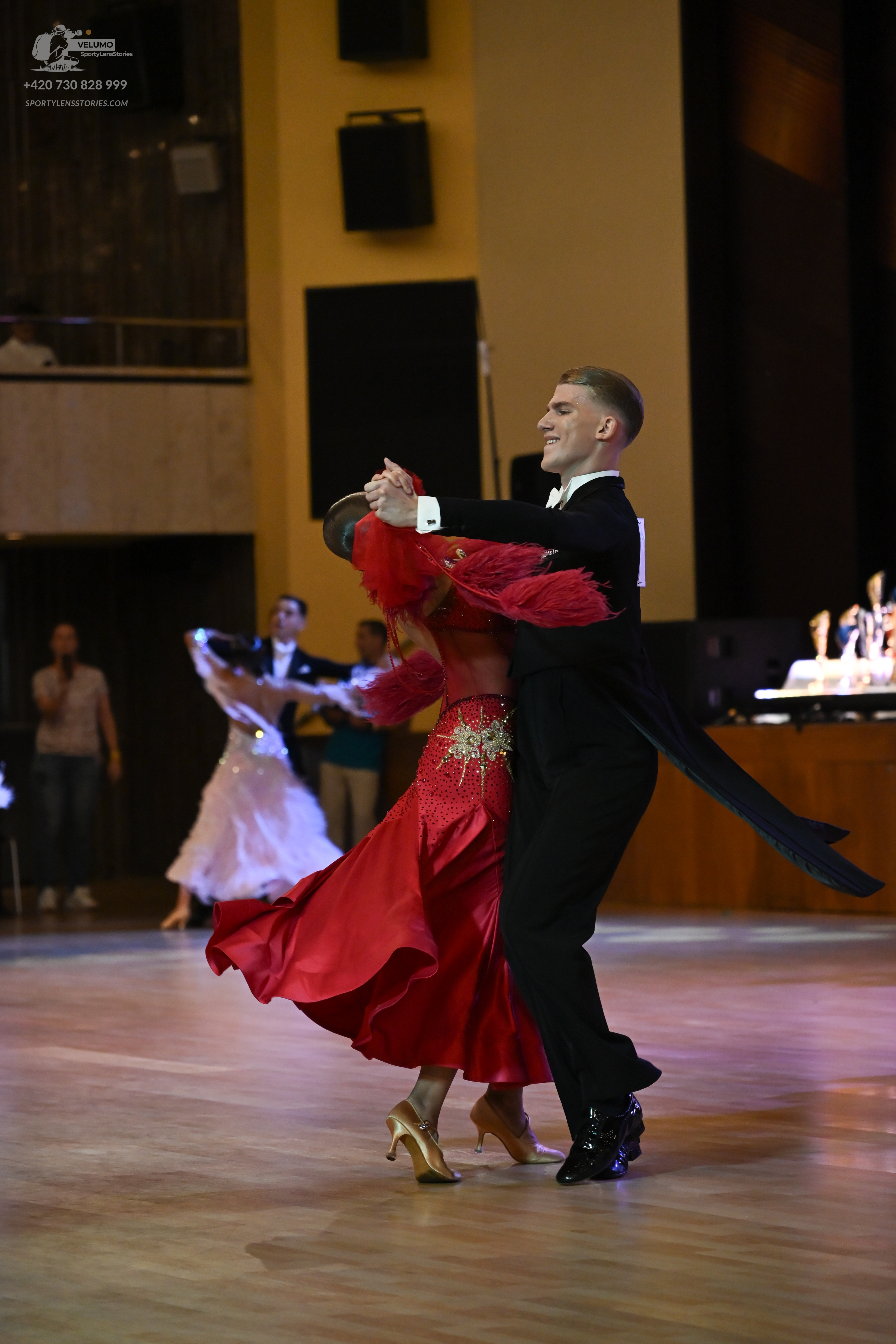 Dancesport competitor: ** Black suit with a sharply tailored jacket and wide, flowing black tails