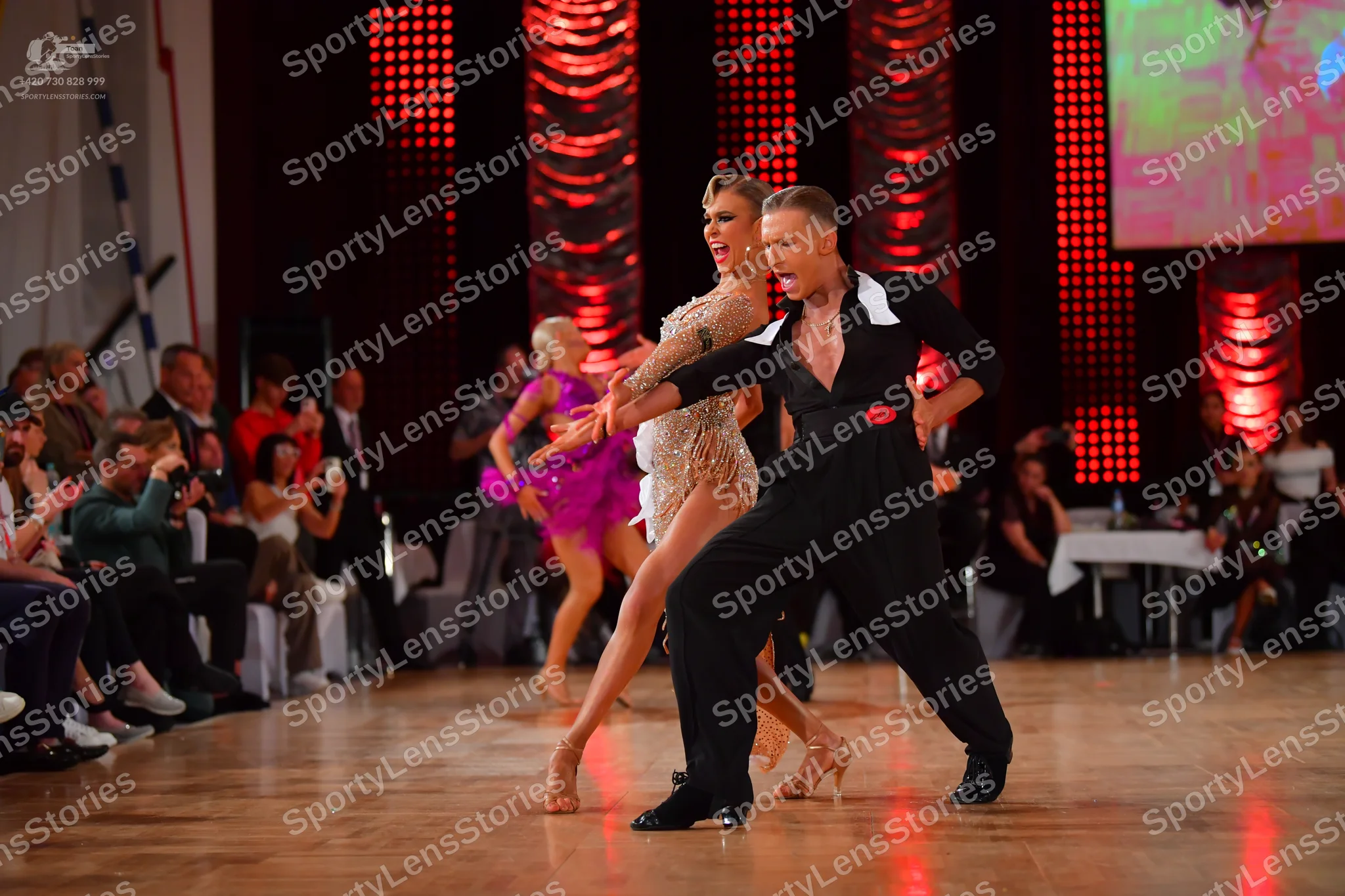 Dancesport competitor: Male dancer: black long-sleeved shirt with a large white collar and black trouse