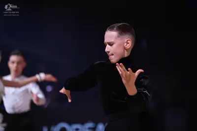 Dancesport competitor: Female dancer: black long-sleeved top