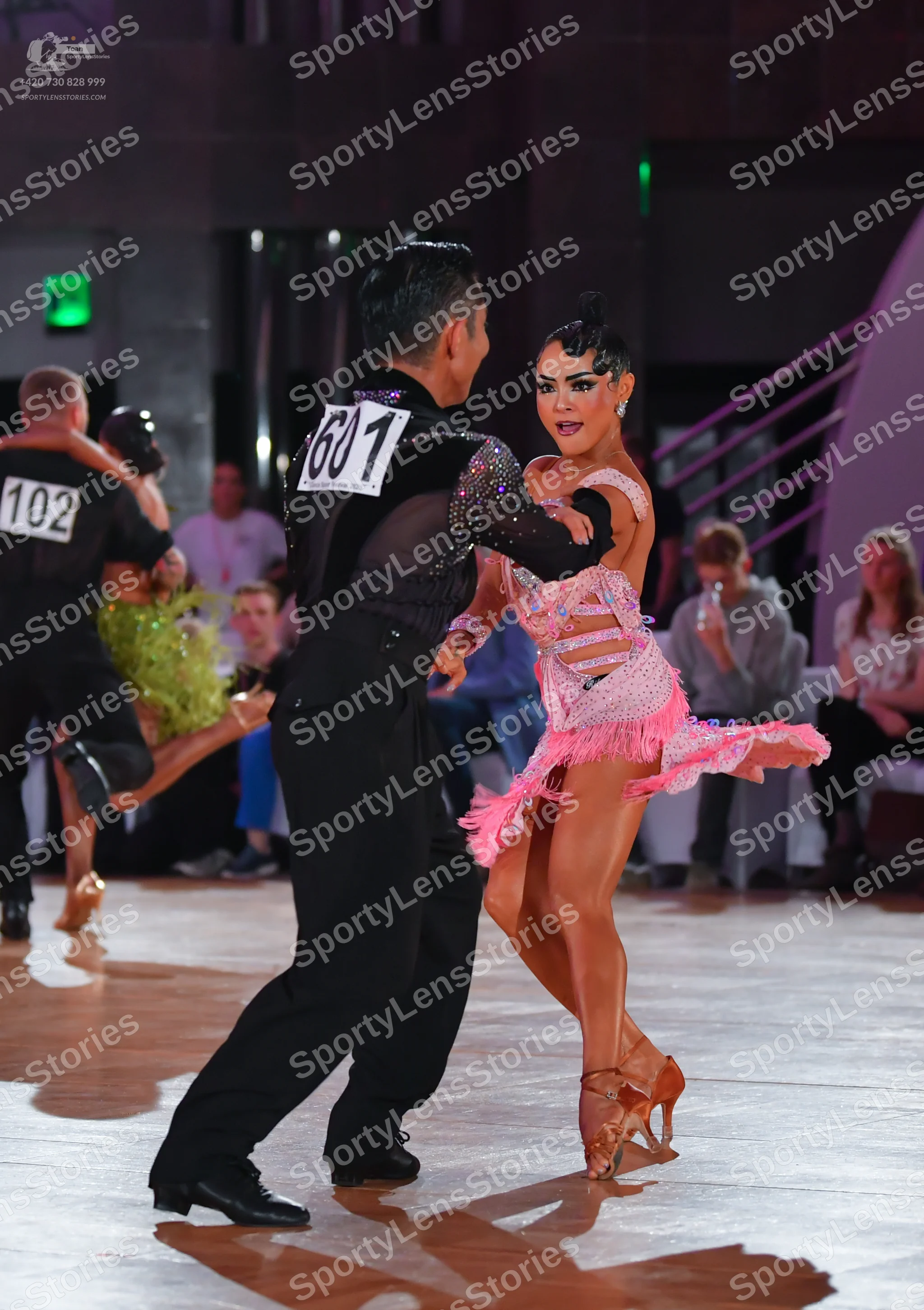 Dancesport competitor #1601, #102: Male dancer (foreground): black shirt with sequins on the upper part and black t