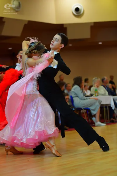 Dancesport competitor: Male dancer: black ballroom suit with a white shirt
