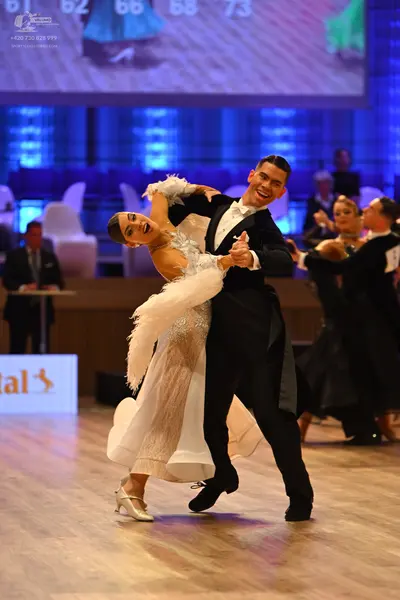 Dancesport competitor: Male dancer: black suit with white shirt and black bowtie
