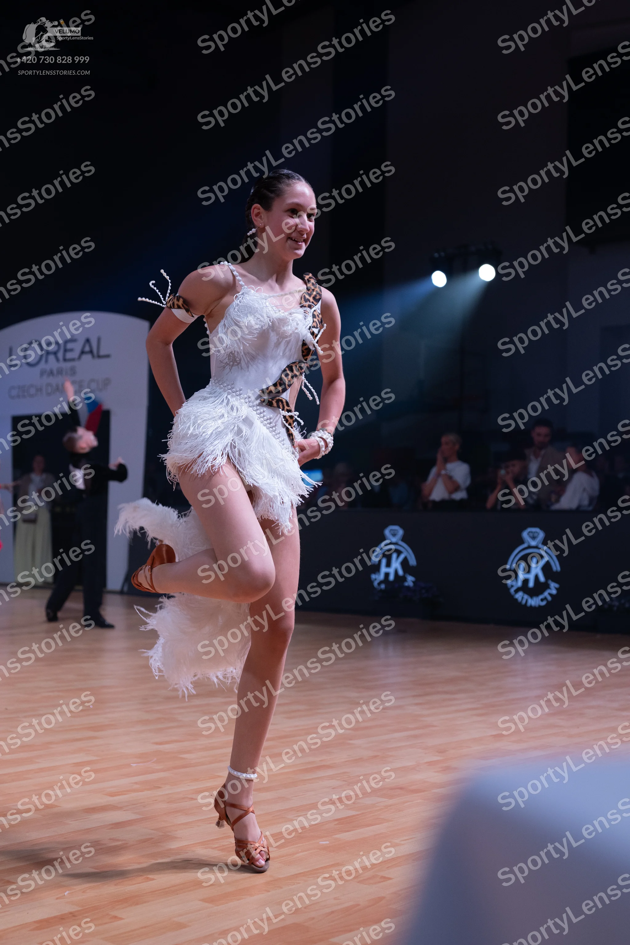 Dancesport competitor: Female dancer: white latin dress with white fringe and leopard print accents, ac