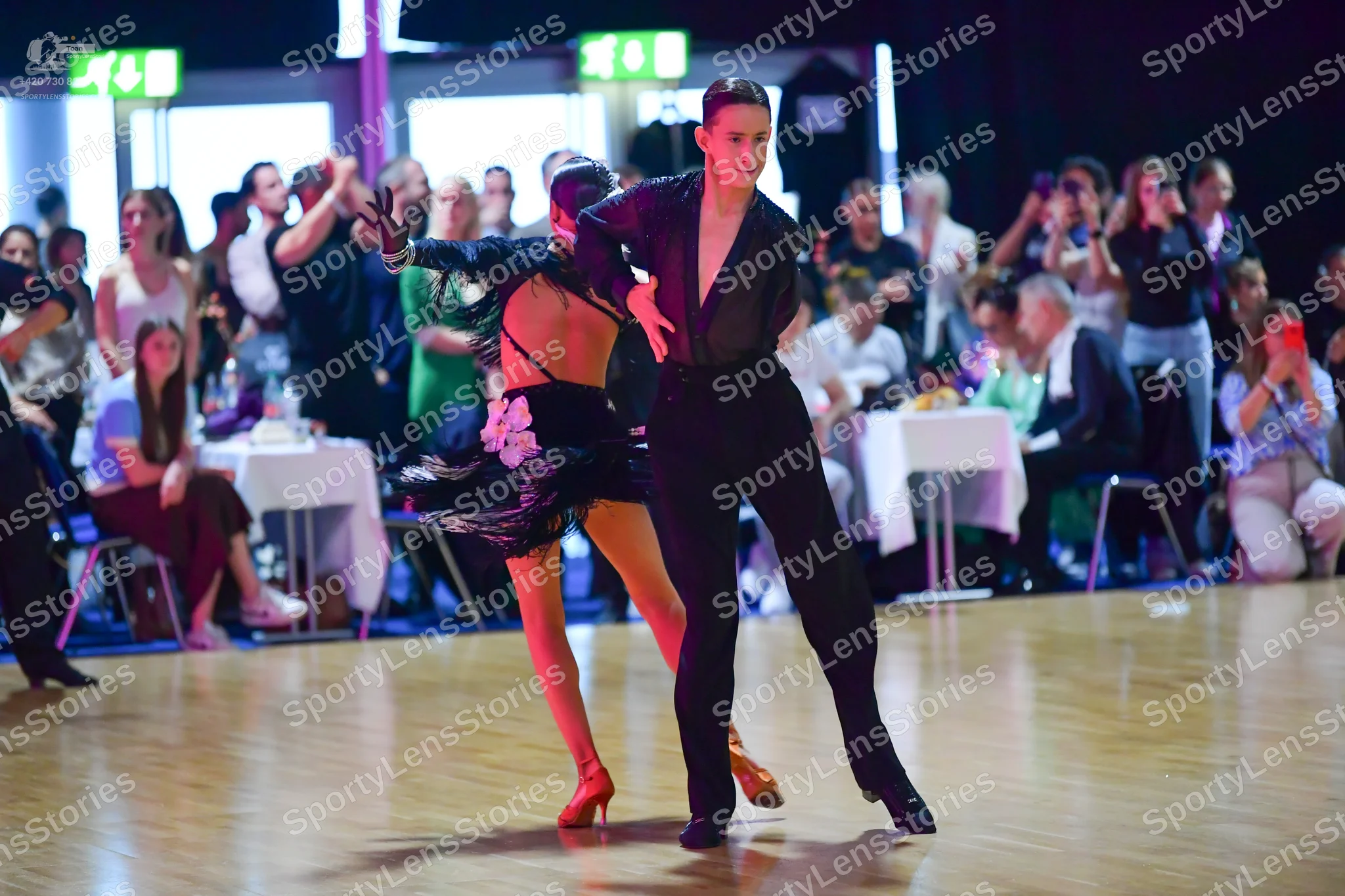 Dancesport competitor: Male dancer: black long-sleeved shirt and black trousers