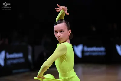 Dancesport competitor: Female dancer: lime green/yellow long-sleeved, tight-fitting dance costume made 
