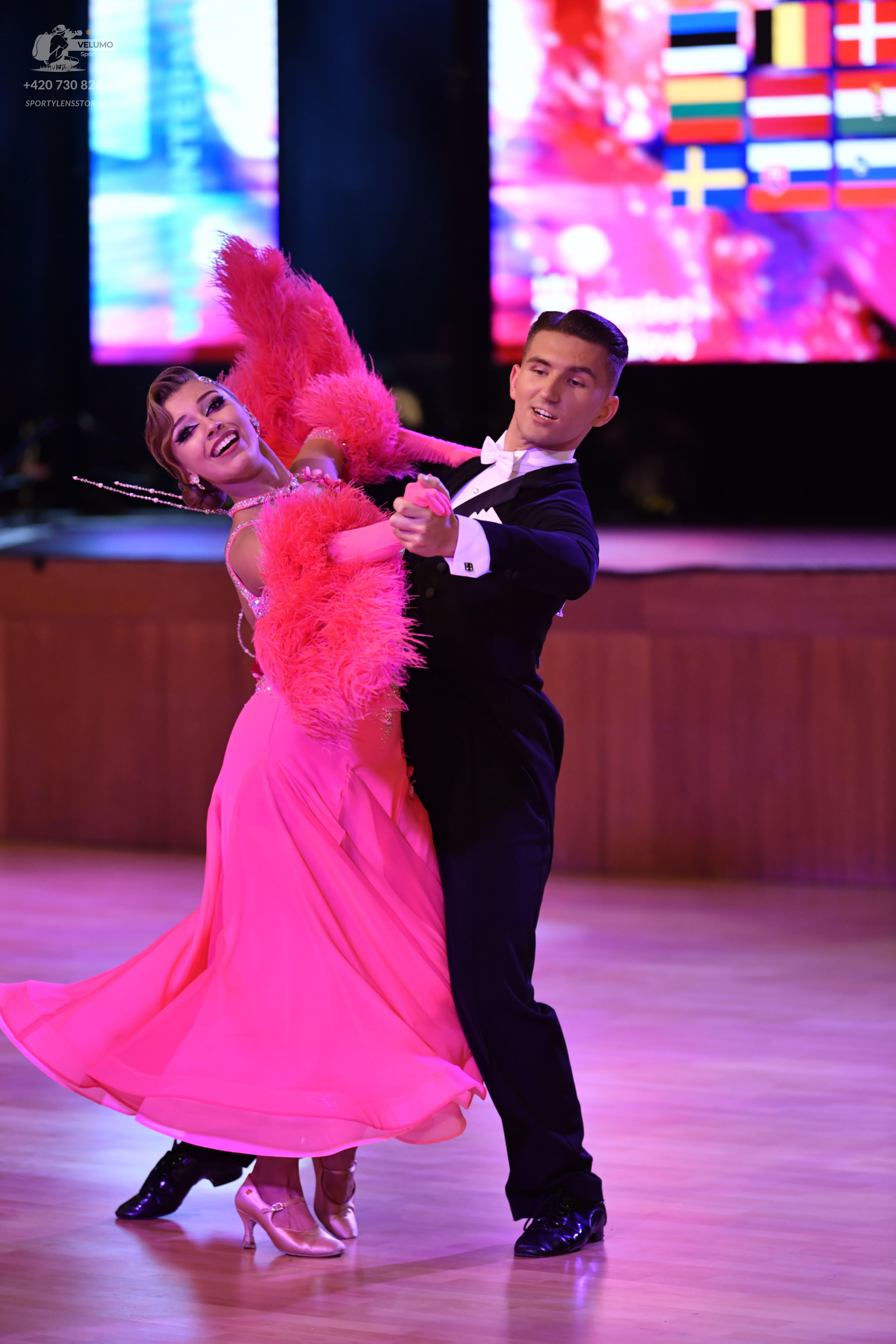 Dancesport competitor: Male dancer: black suit with a white shirt and white bow tie