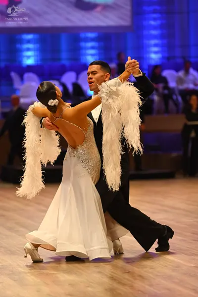 Dancesport competitor: Male dancer: black suit with white shirt