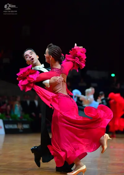 Dancesport competitor: Male dancer: black suit, white shirt, and black bow tie
