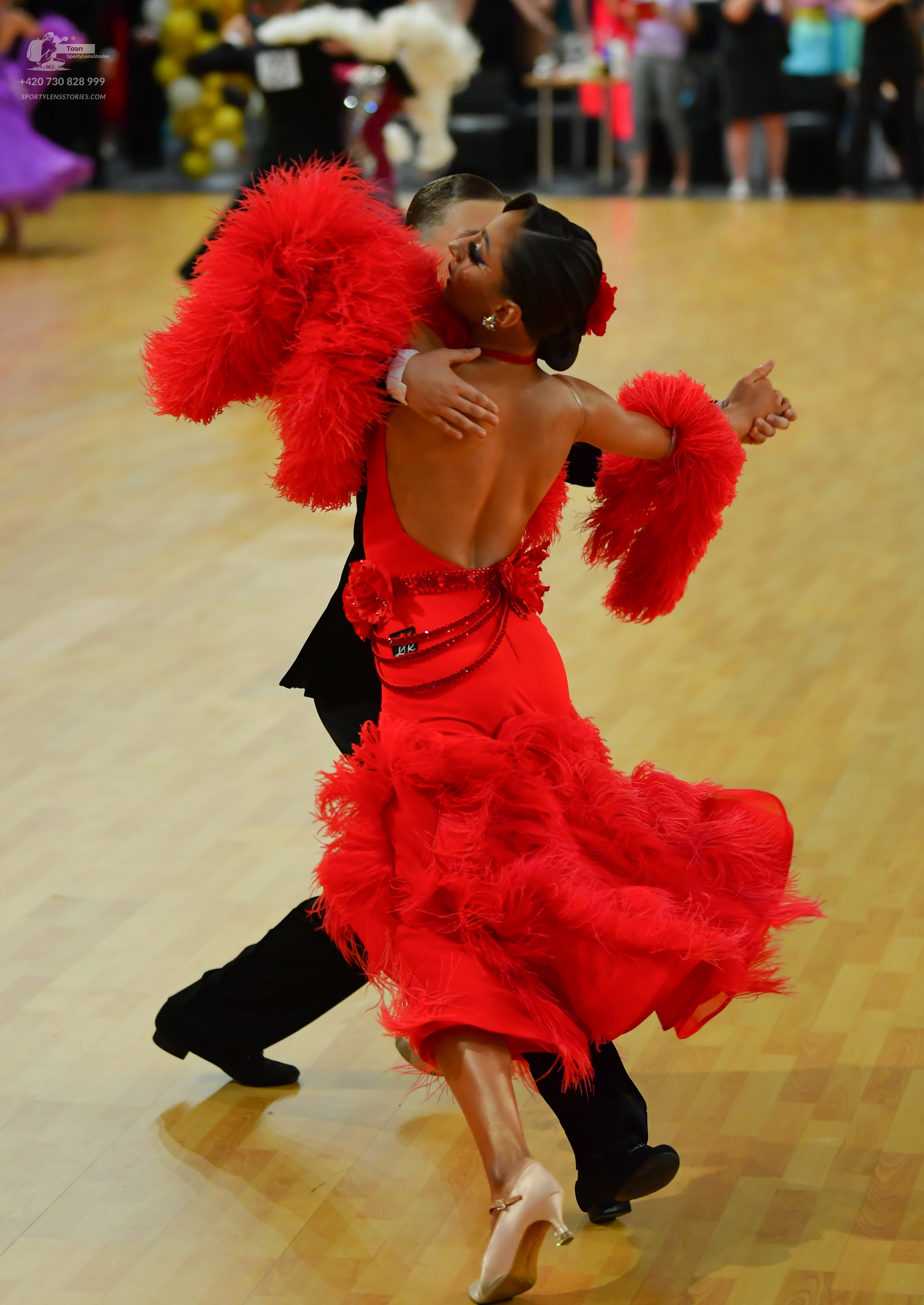 Dancesport competitor: ** Red Latin Dress
*   **Fabric:** Satin (appears to be a shimmering satin)
*   