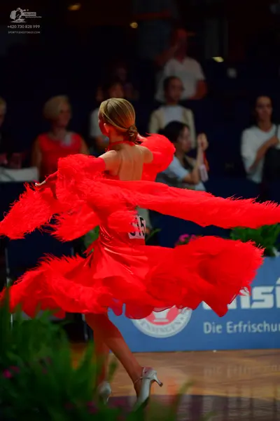 Dancesport competitor #38: Female dancer: red latin dress with voluminous feather-like fringe