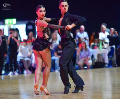 Dancesport competitor: Male dancer: black long-sleeved shirt and black trousers