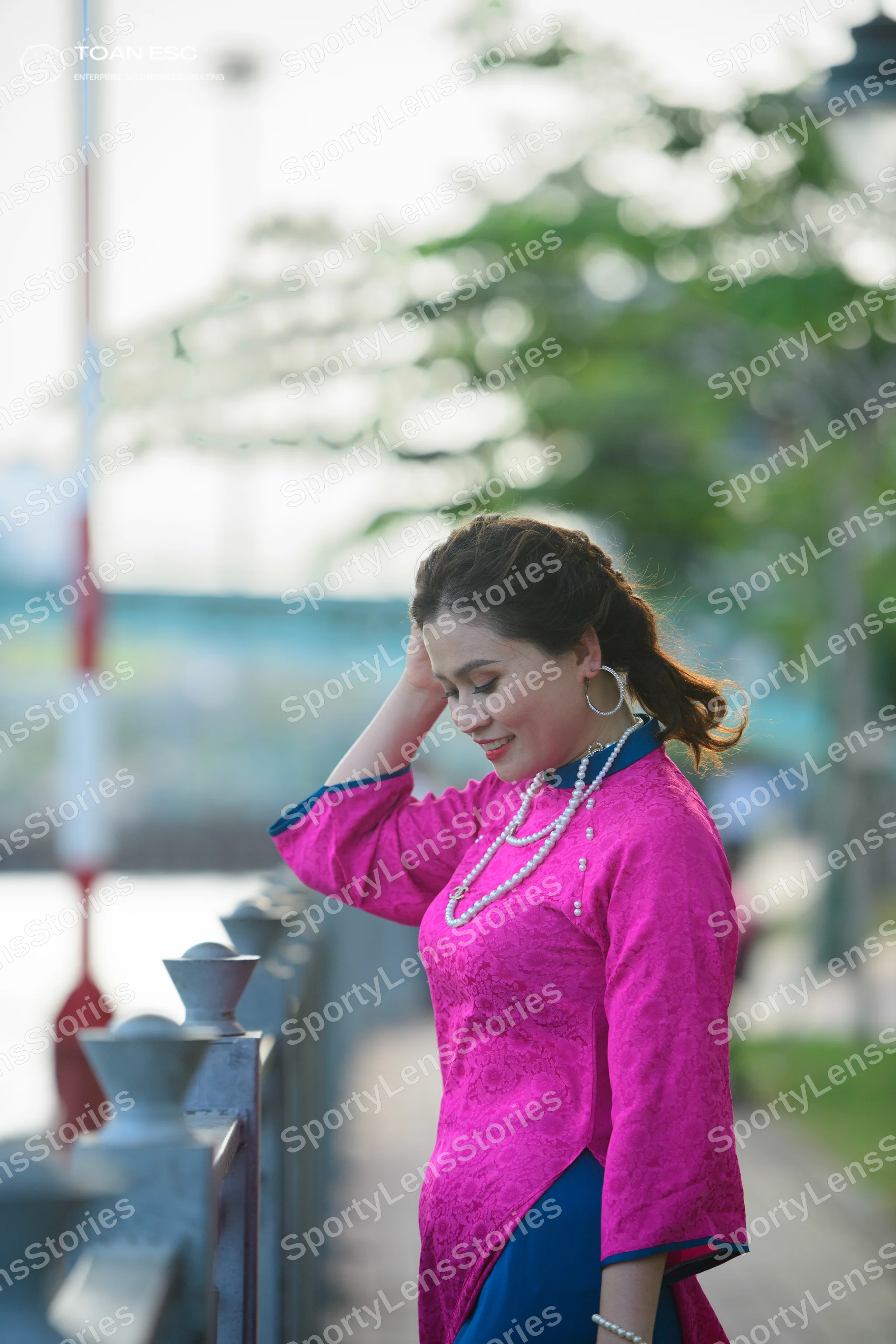 Dancesport competitor: Female dancer: bright pink long-sleeved top with a subtle textured pattern and d