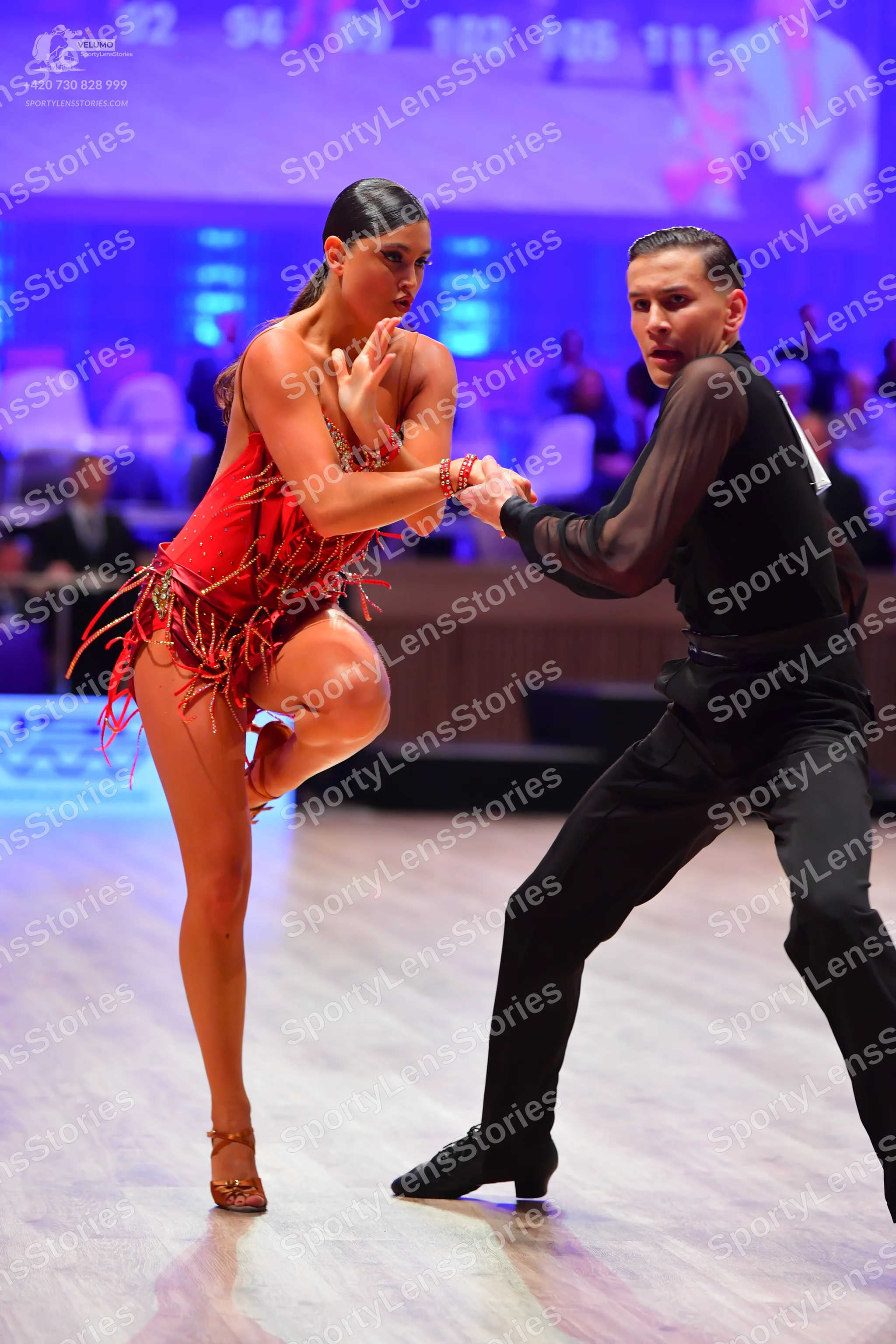 Dancesport competitor: Female dancer: red latin dress with fringe and thin straps