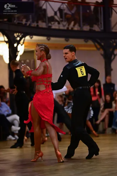 Dancesport competitor: Male dancer: black long-sleeved shirt and black trousers