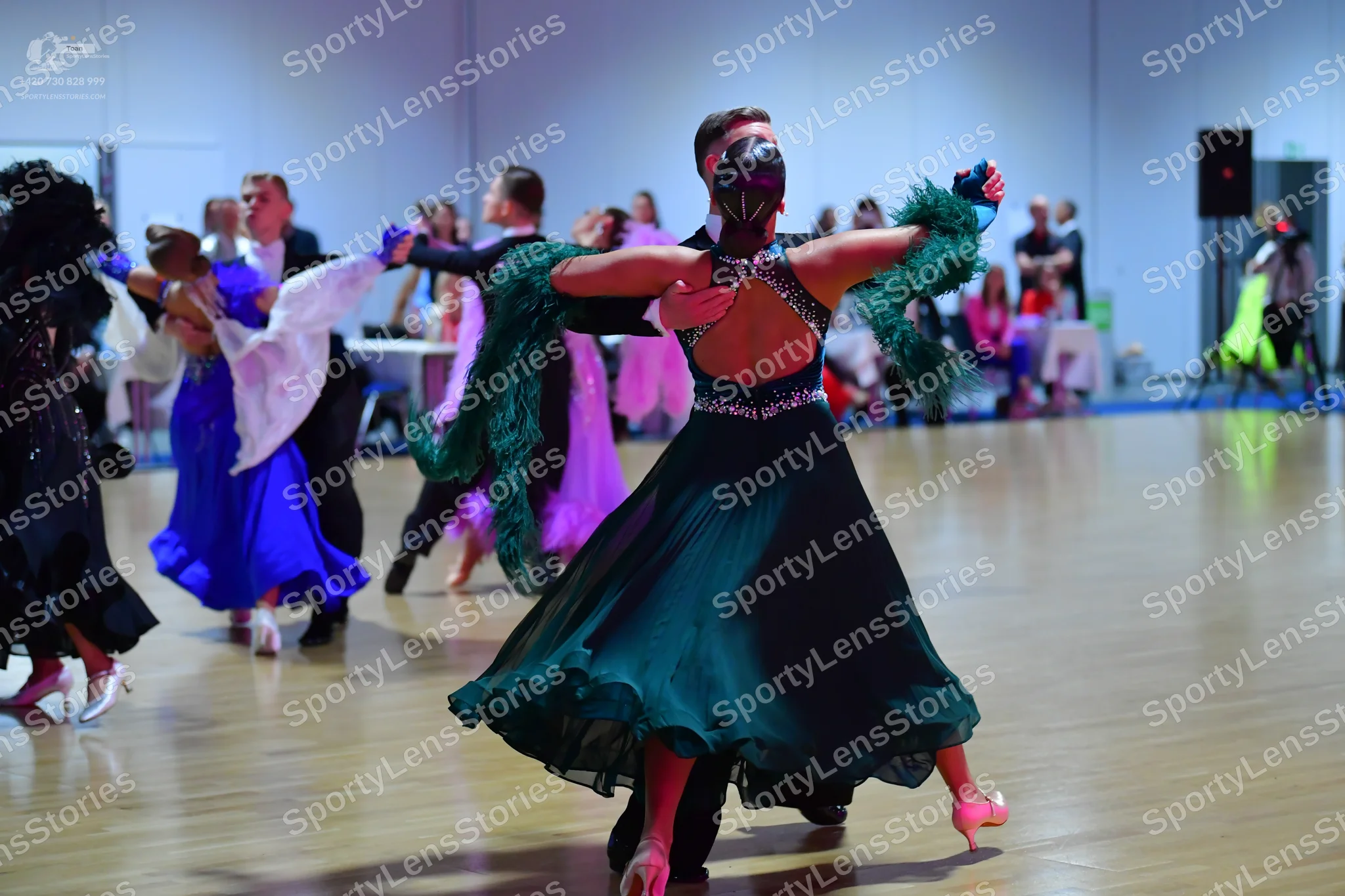 Dancesport competitor: Female dancer (left): black ballroom dress