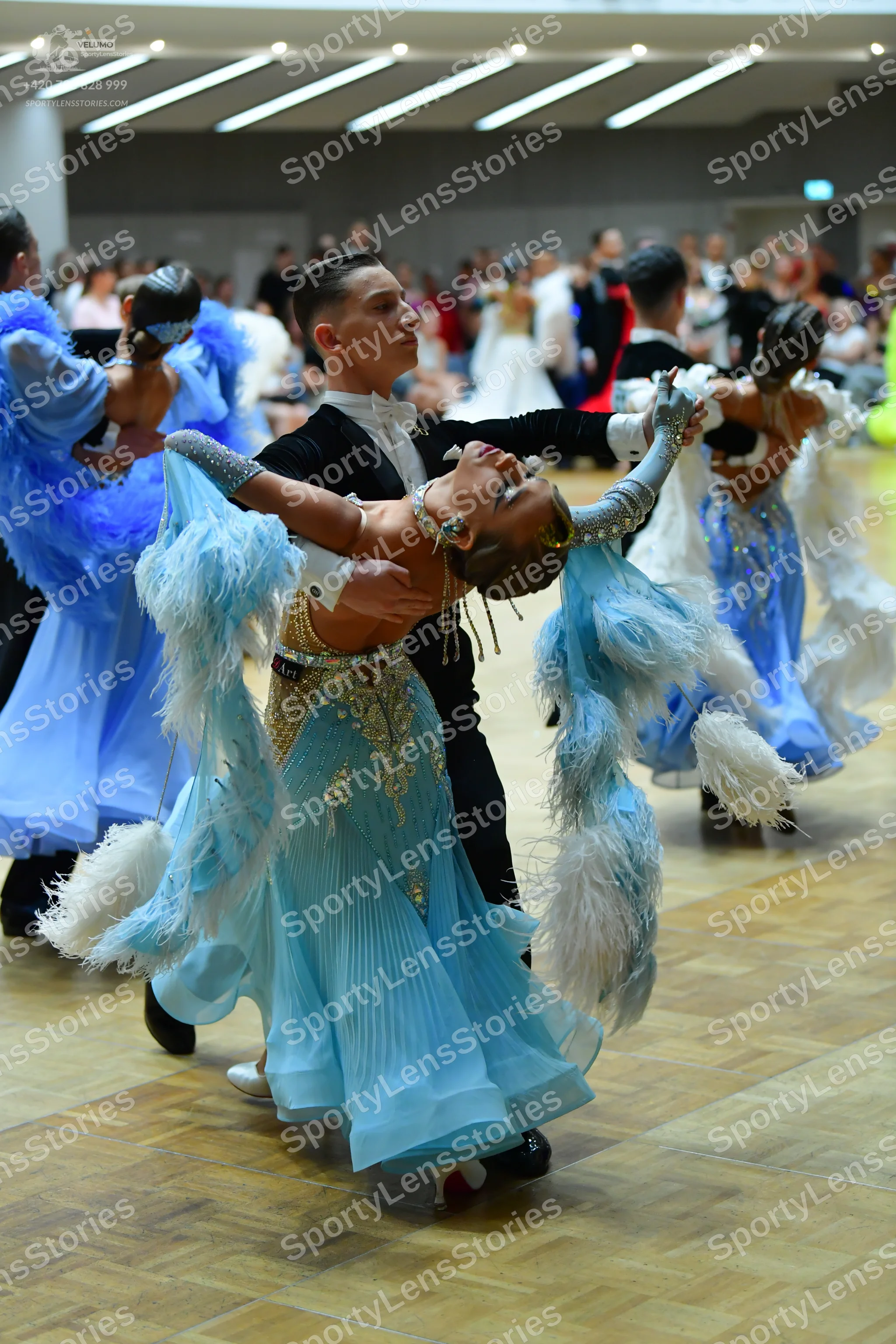 Dancesport competitor: Male dancer: black suit with a white shirt and white bowtie
