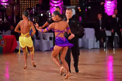 Dancesport competitor: Female dancer: yellow Latin costume with fringe