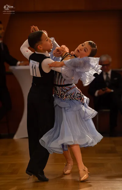 Dancesport competitor #11: Male dancer: black and white waistcoat-style top with black trousers and black d