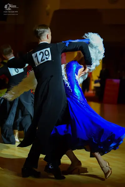 Dancesport competitor: ** Black tail suit with silver sequin lapels