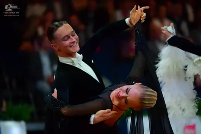 Dancesport competitor: Male dancer: black suit with a white shirt and white bow tie
