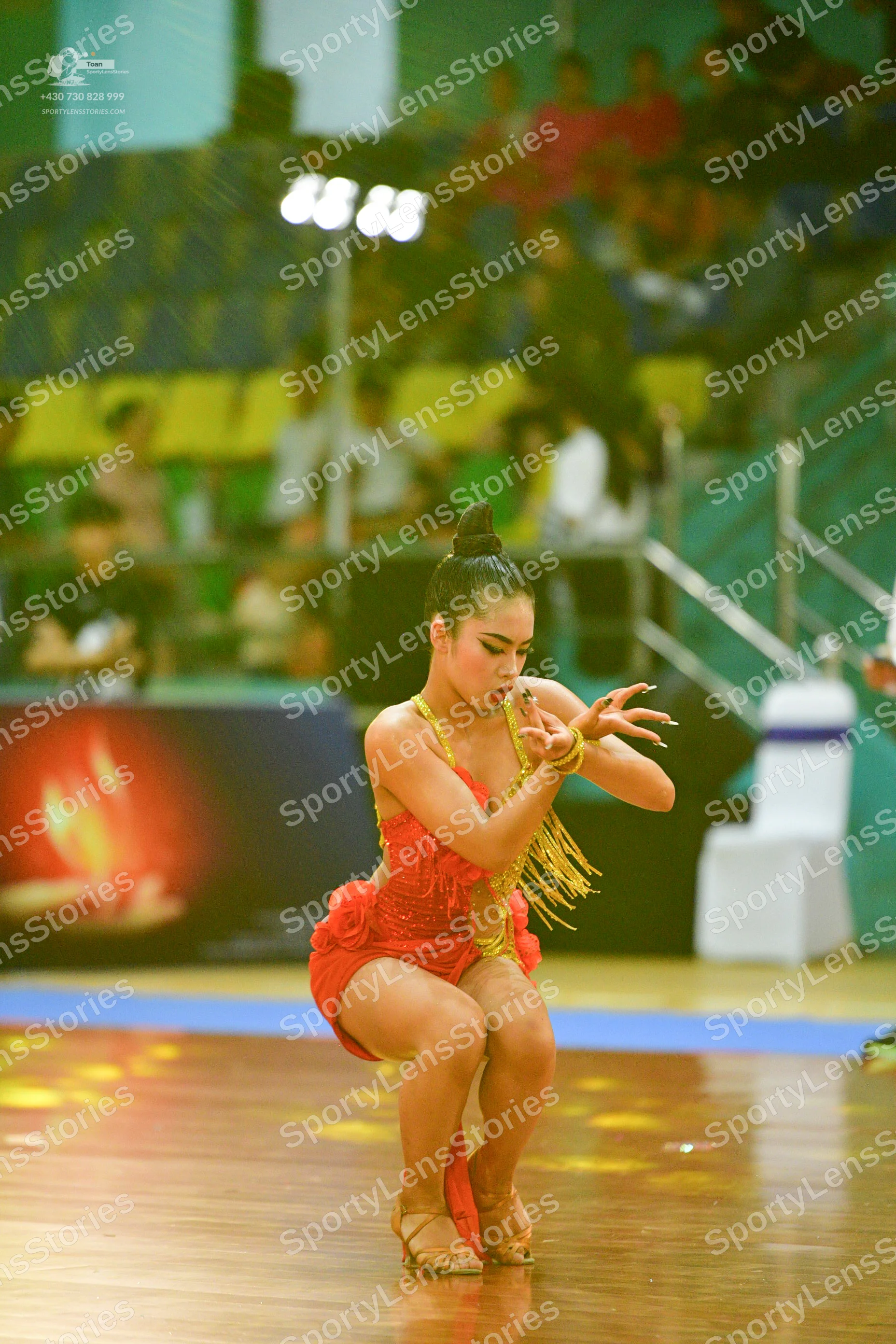 Dancesport competitor: ** Red Latin dress
*   **Color:** Primarily a vibrant red