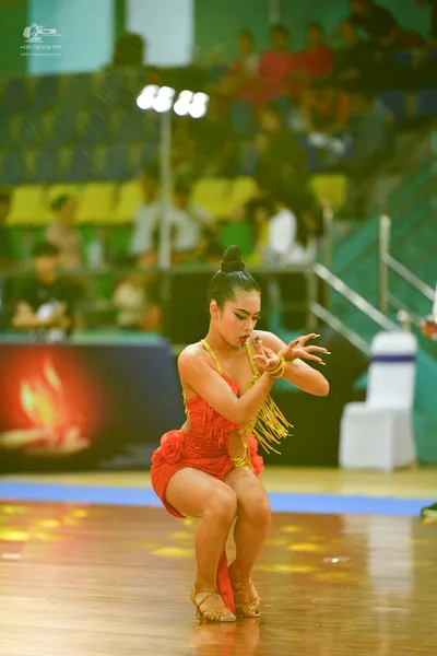 Dancesport competitor: ** Red Latin dress
*   **Color:** Primarily a vibrant red