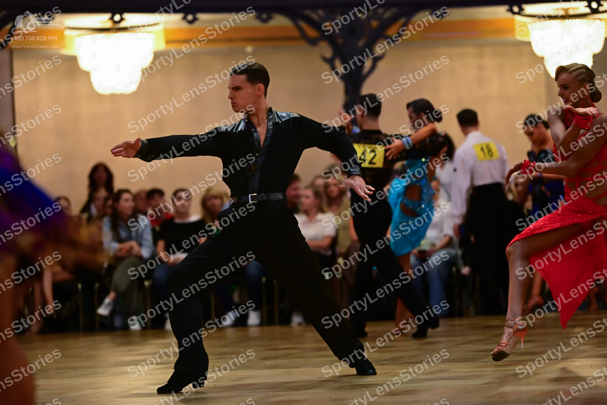 Dancesport competitor: Male dancer: black long-sleeve shirt with satin-like texture and black trousers