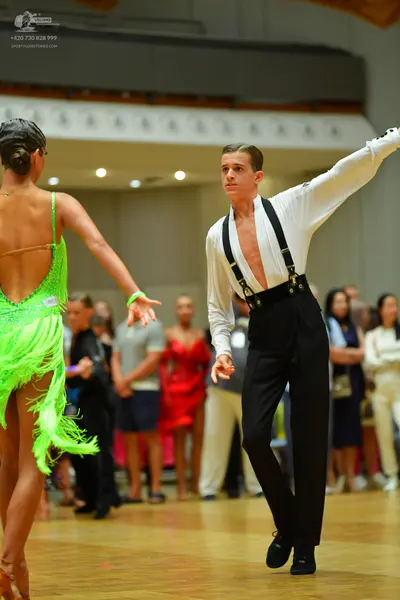 Dancesport competitor: Female dancer: neon green Latin dress with sequins and fringe