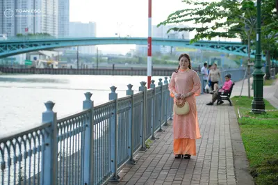 Dancesport competitor: Female dancer: long, peach-colored, flowing dress