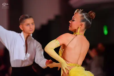 Dancesport competitor: Male dancer: white long-sleeve shirt and black trousers