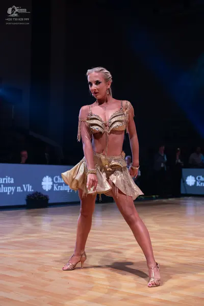 Dancesport competitor: Female dancer: gold/champagne two-piece Latin dance costume featuring sequins/me