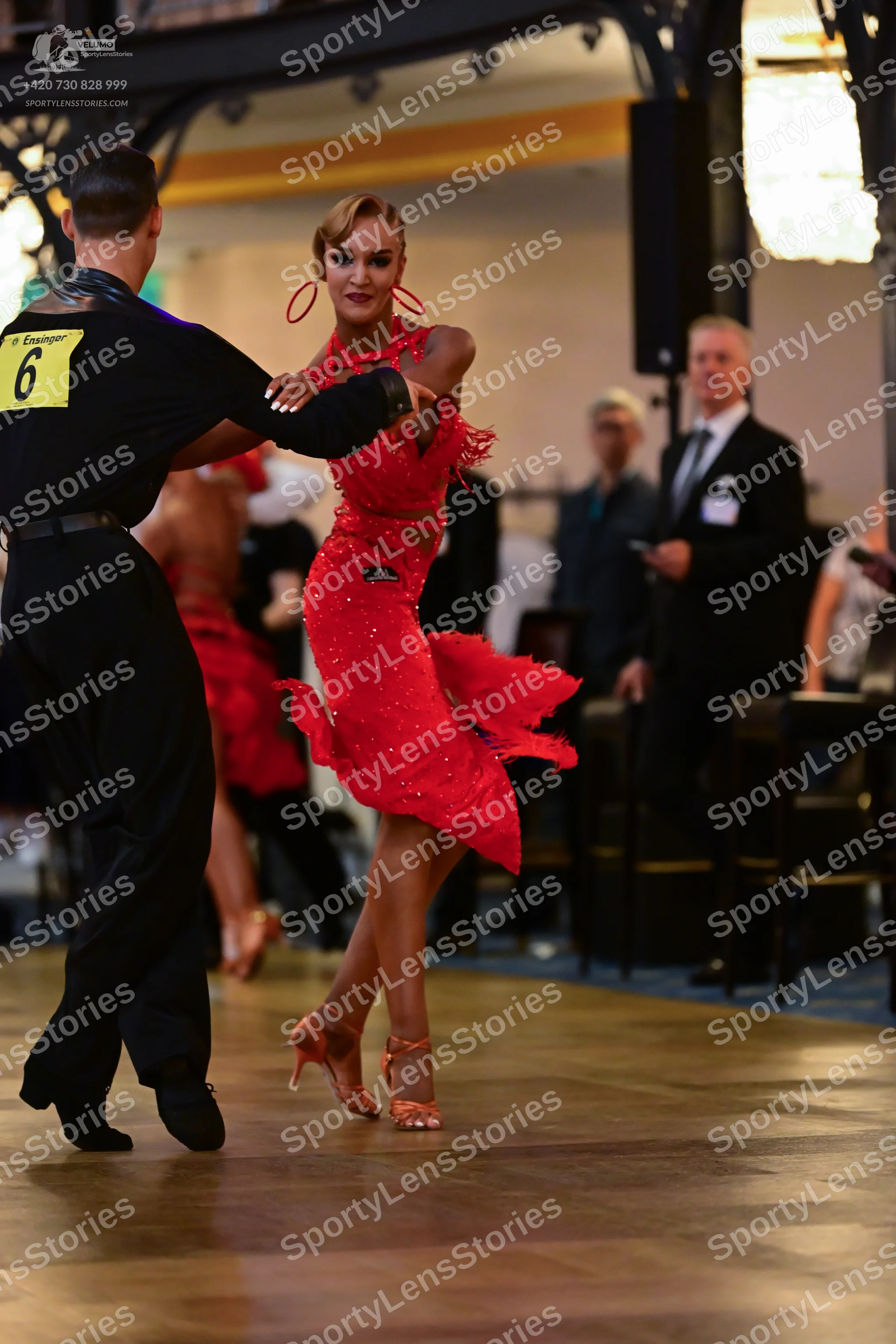 Dancesport competitor: Male dancer: black long-sleeved shirt with satin-like detailing on the shoulders