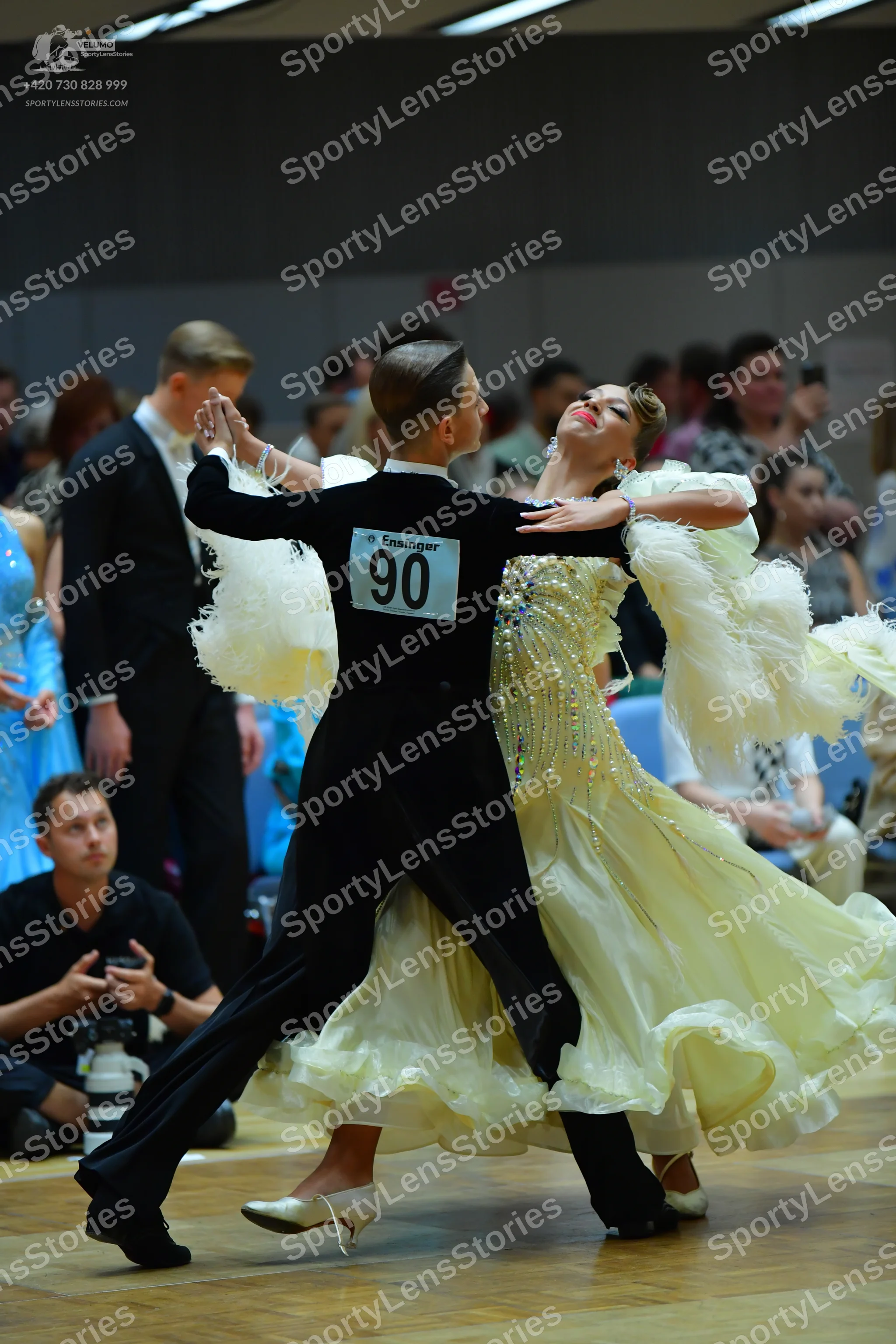 Dancesport competitor #90: Male dancer: black long-sleeved shirt with white ruffled details on the back and